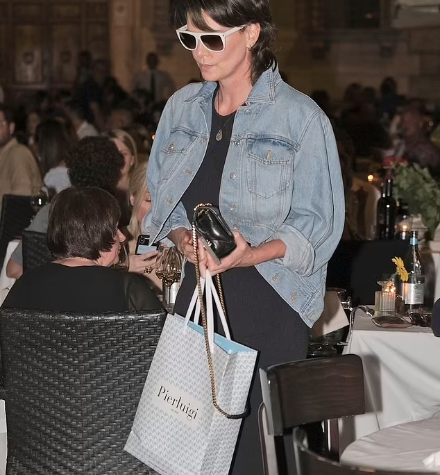 Charlize Theron looks every inch the doting mother as she enjoys a family meal in Rome with daughters Jackson, 10, and August, 7